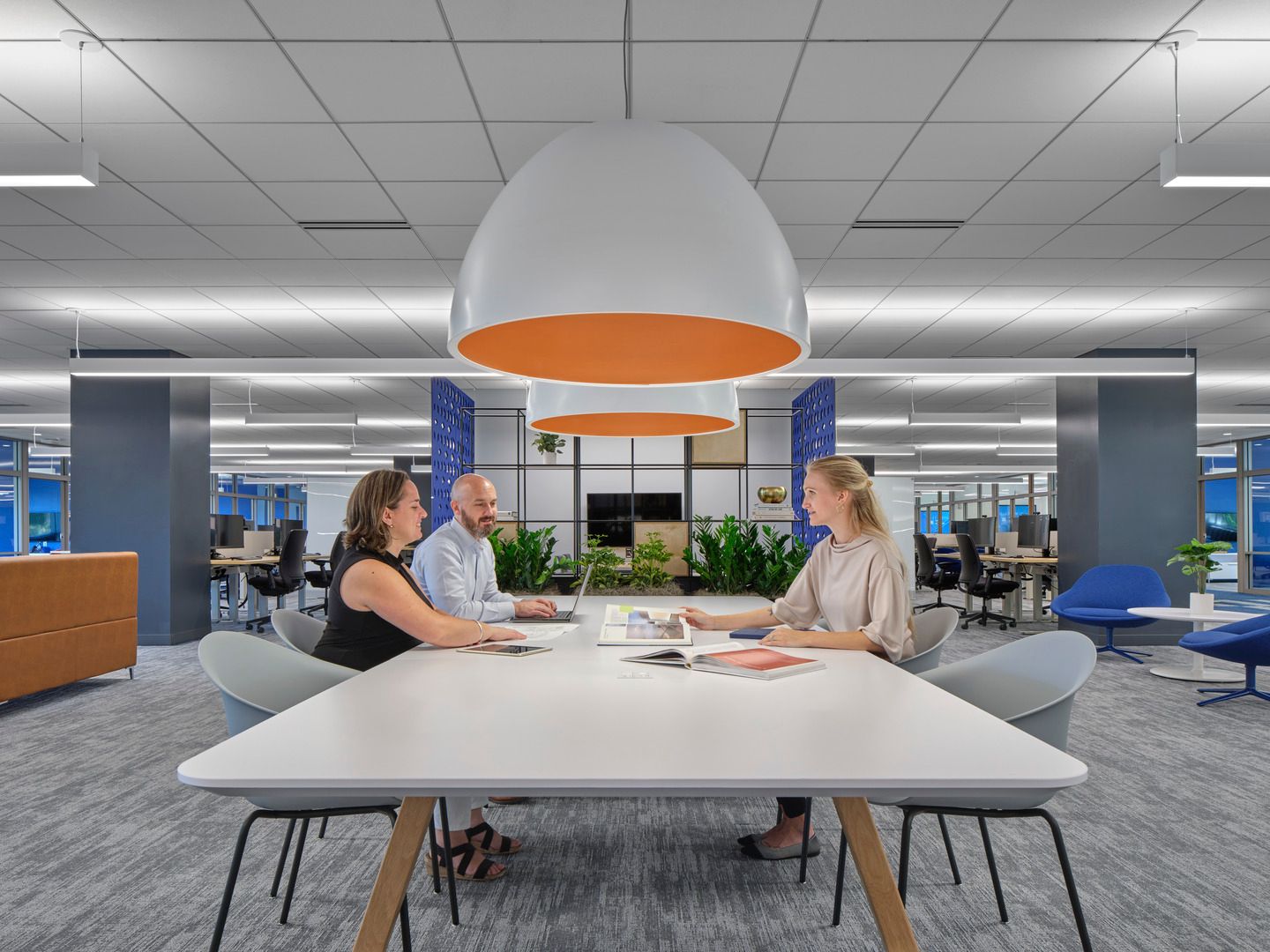 small group of people sitting at a table having a meeting