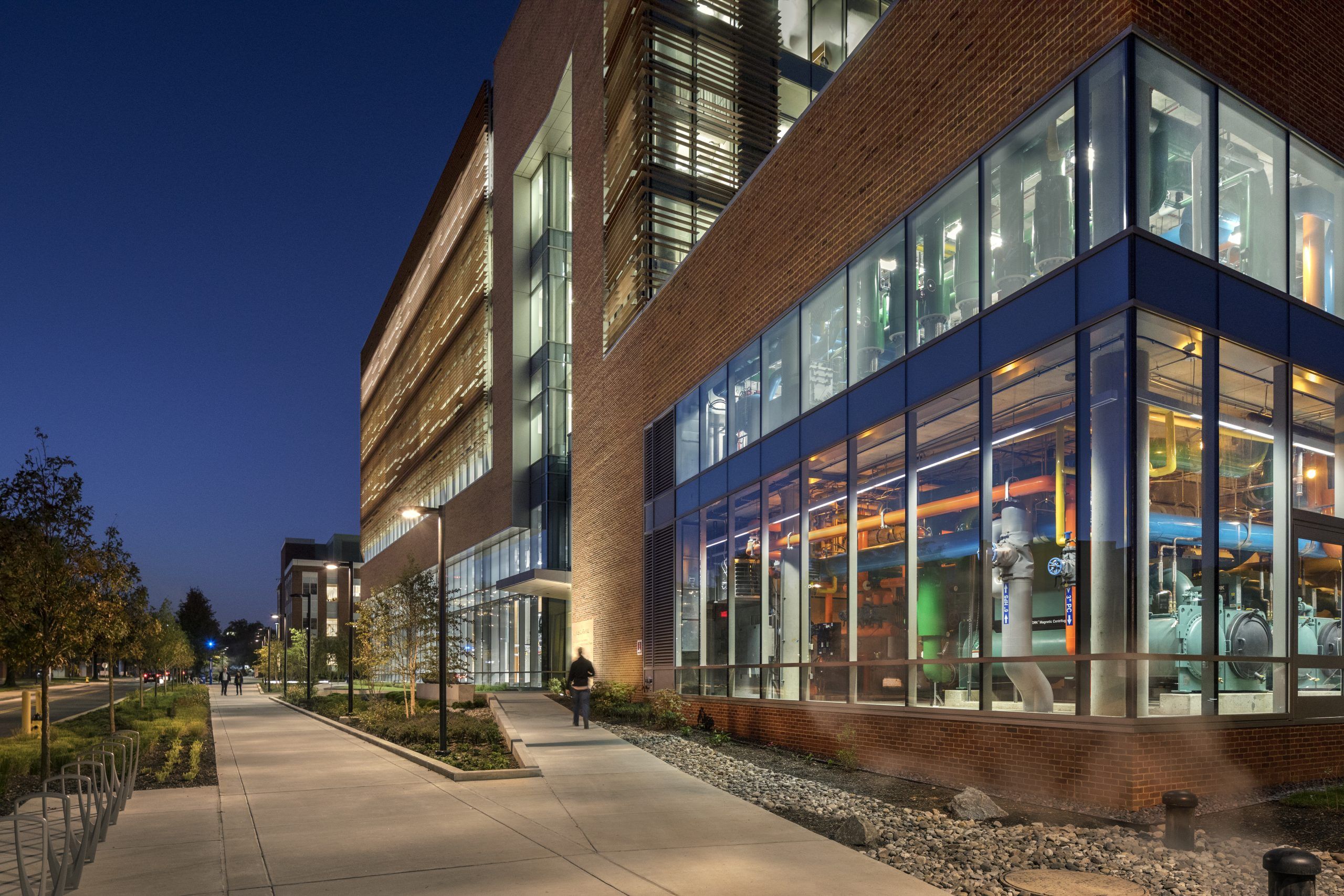 Night view of A. James Clark building interior with pathways and entrance lit on left