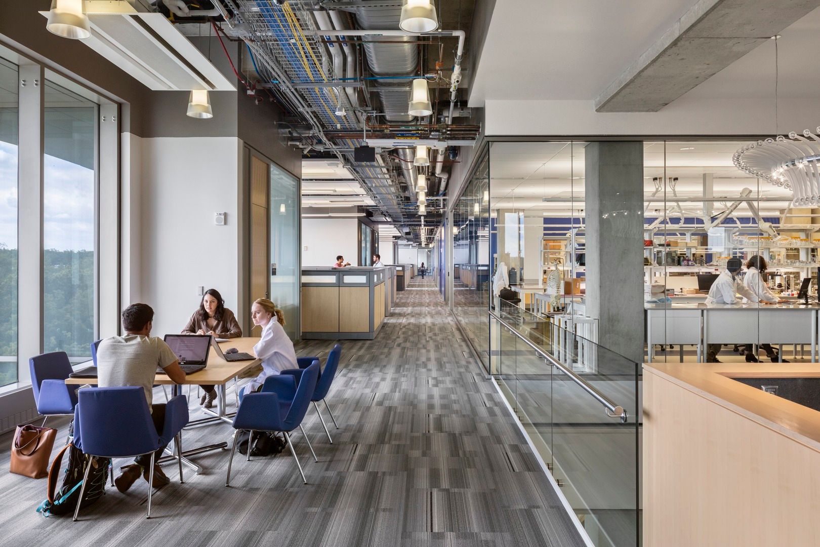 Open meeting space in A. James Clark building with purple chairs and dry labs in background