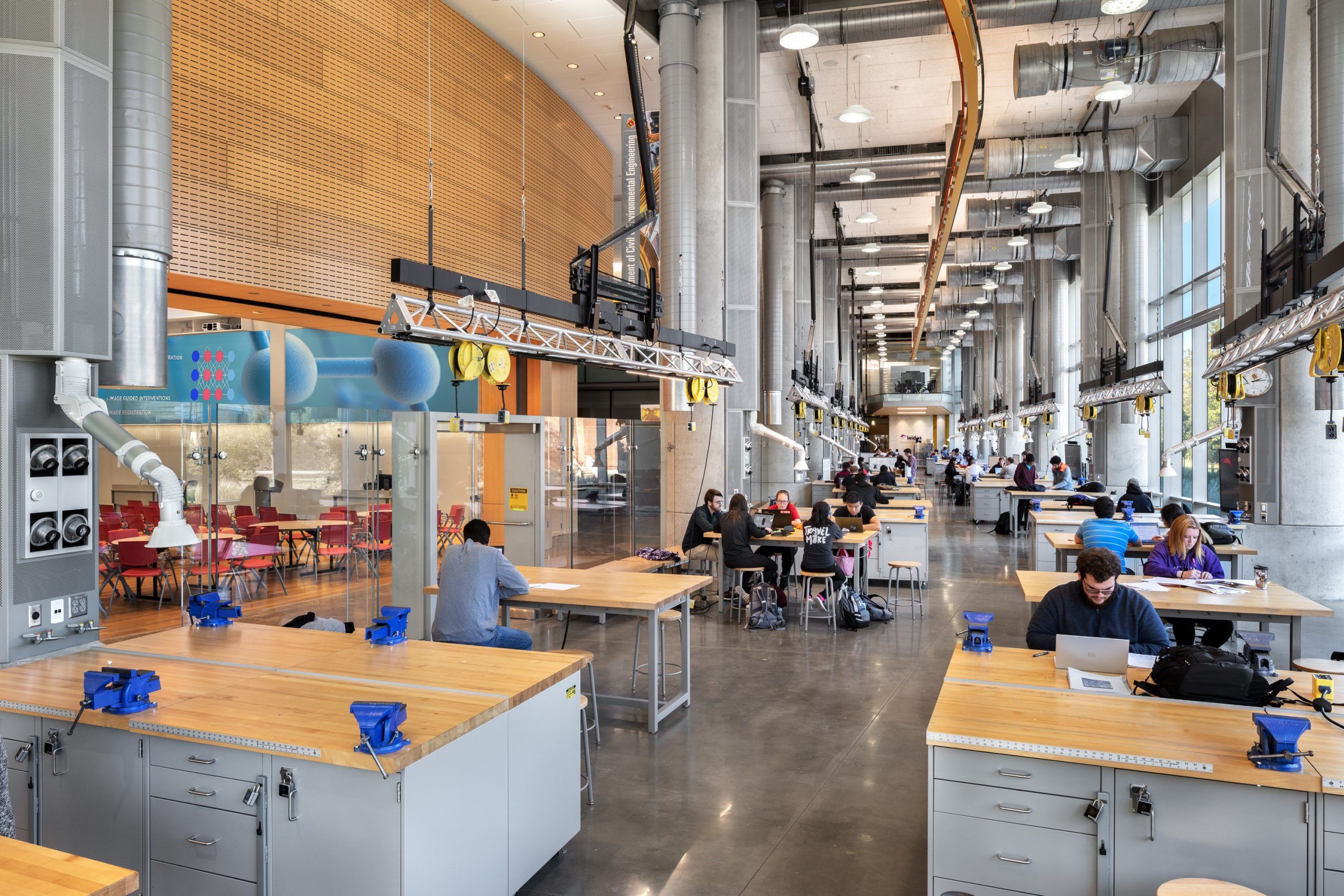 Maker space with exposed engineering systems and workstations in an open floorplan