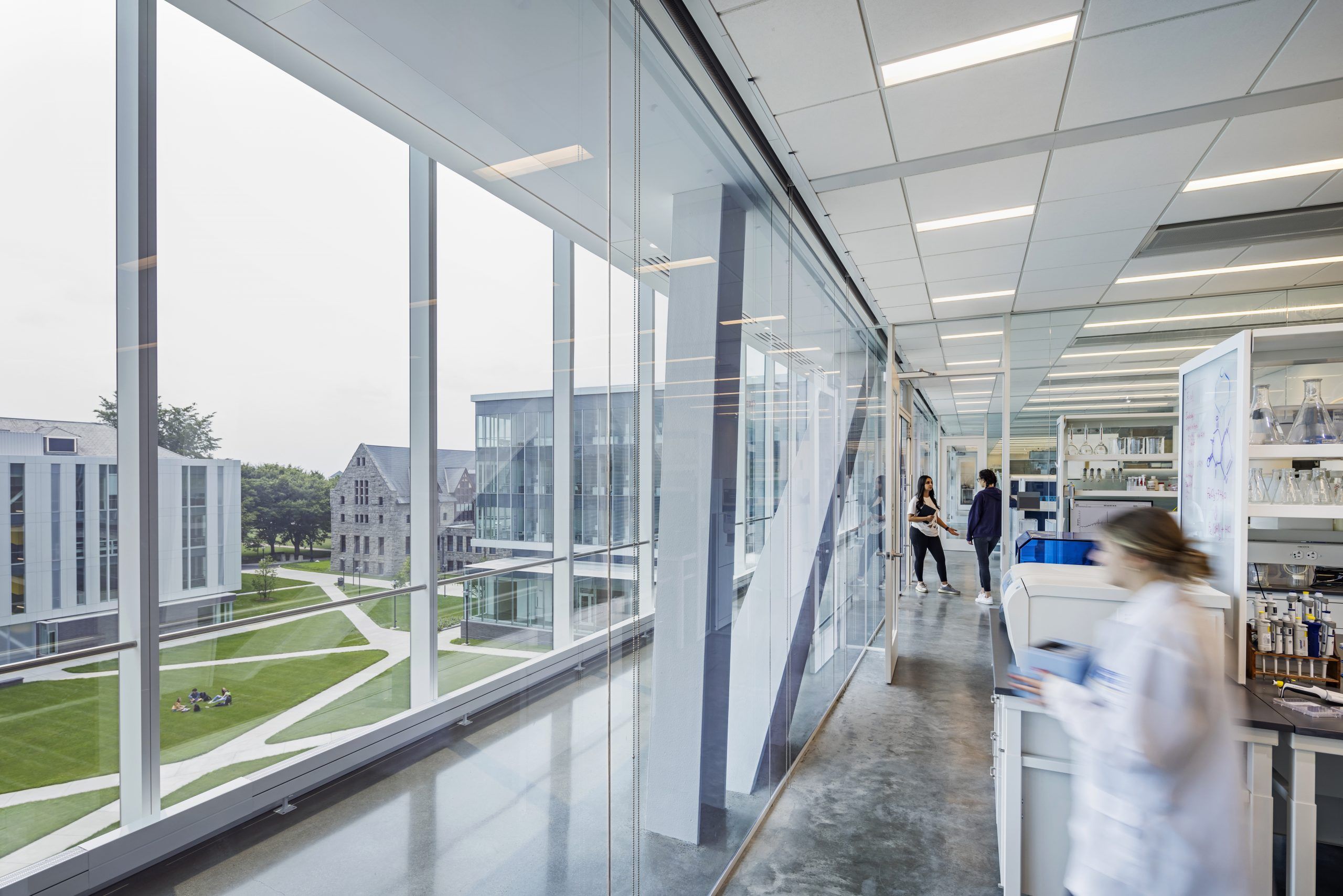 A student in a lab coat working in the brand new Fascitelli Center for Advanced Engineering