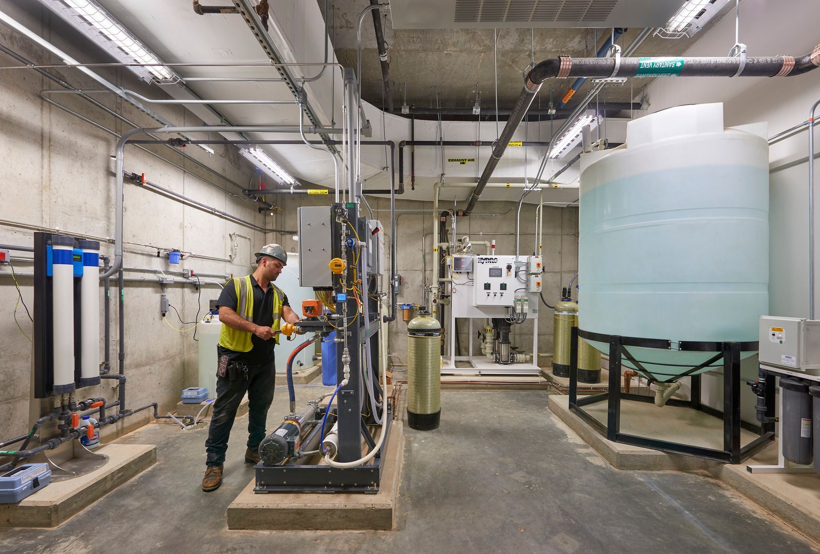 Maintenance worker adjusting building engineering system