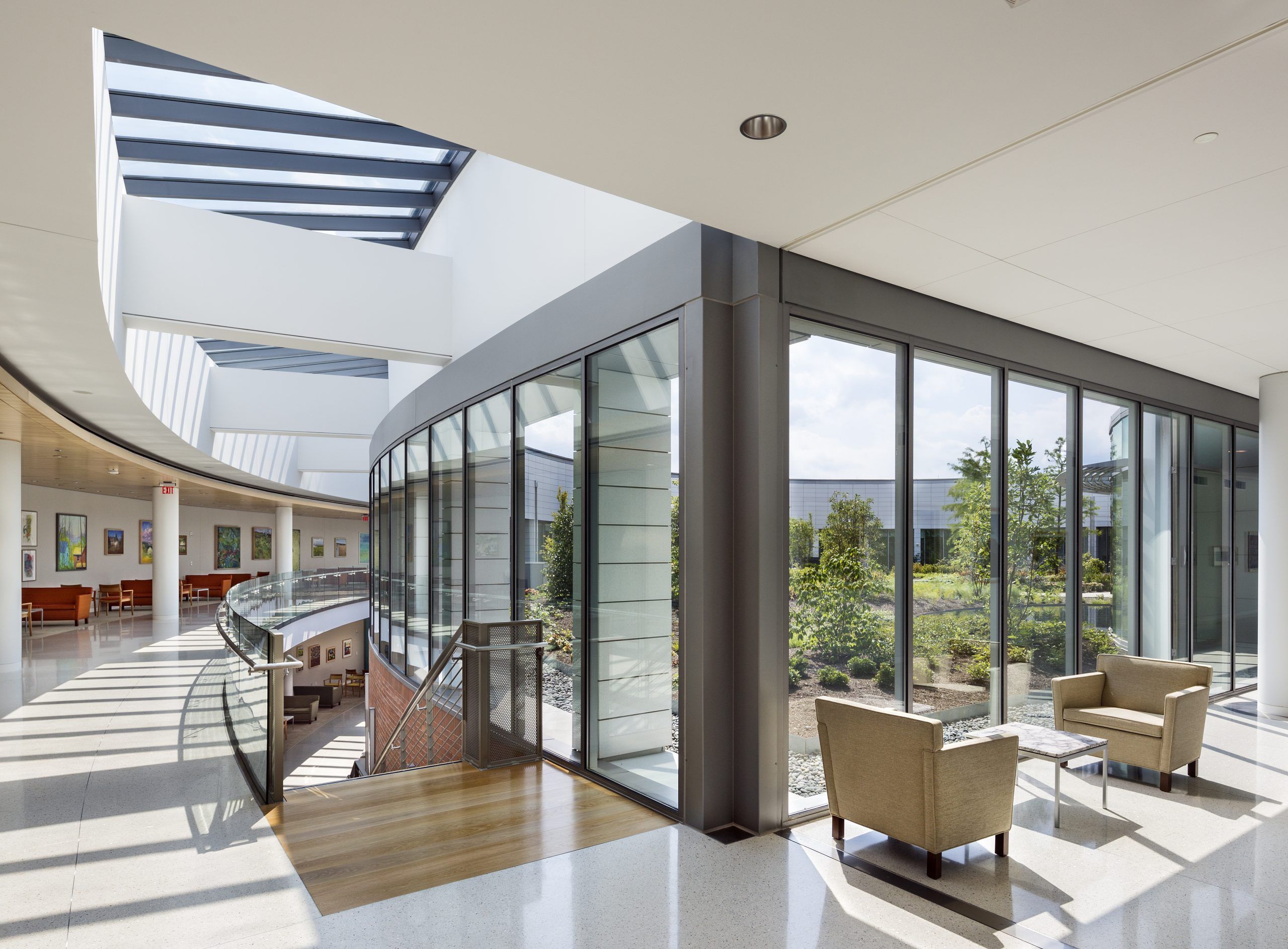 Open hallway with a staircase and seating area