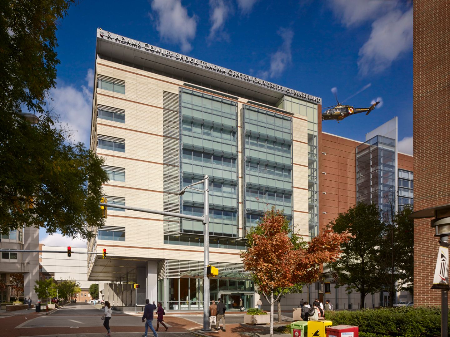 Street view of hospital with medical transport helicopter landing on roof