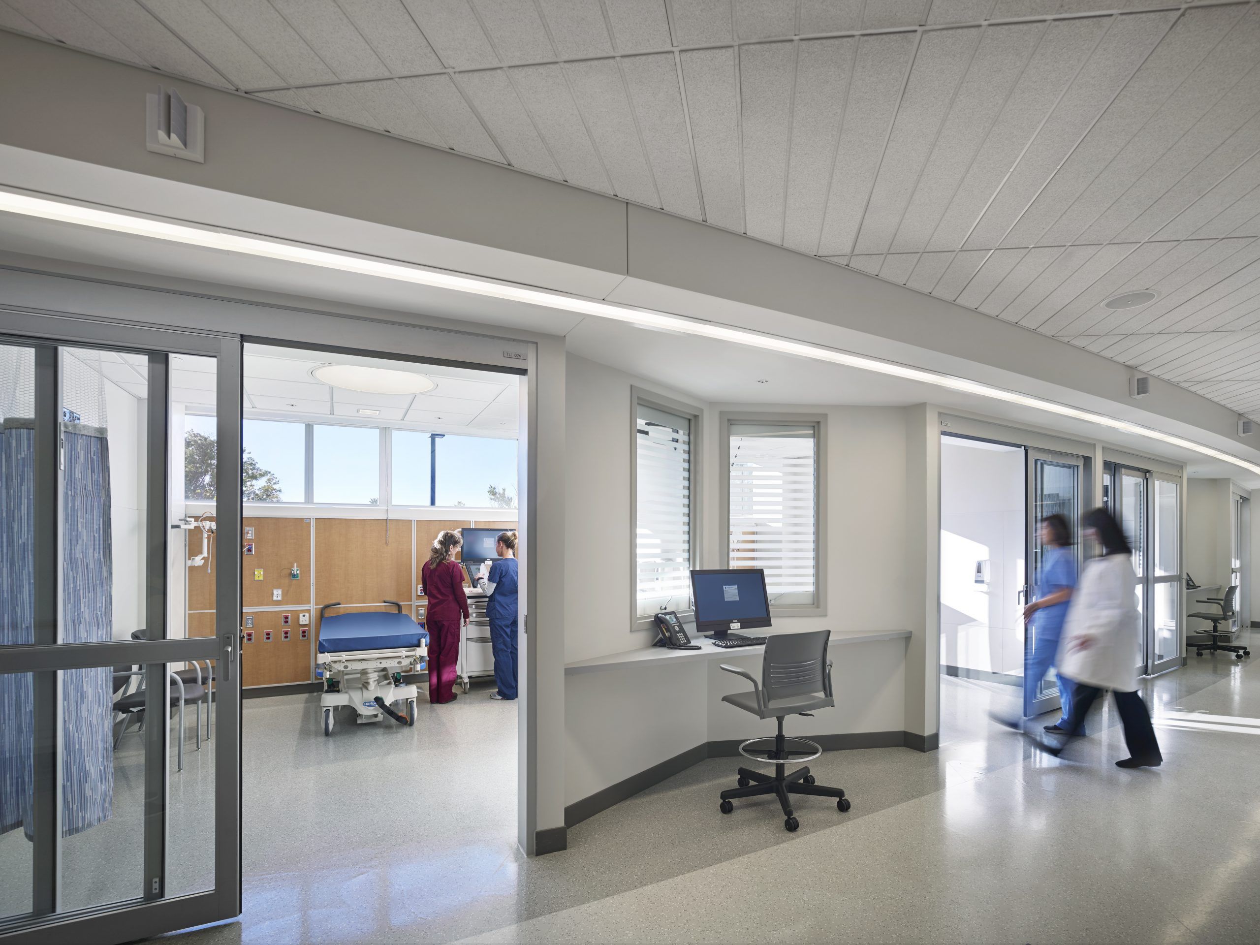 View of a nurses' station outside a patient room with clerestory windows and natural light