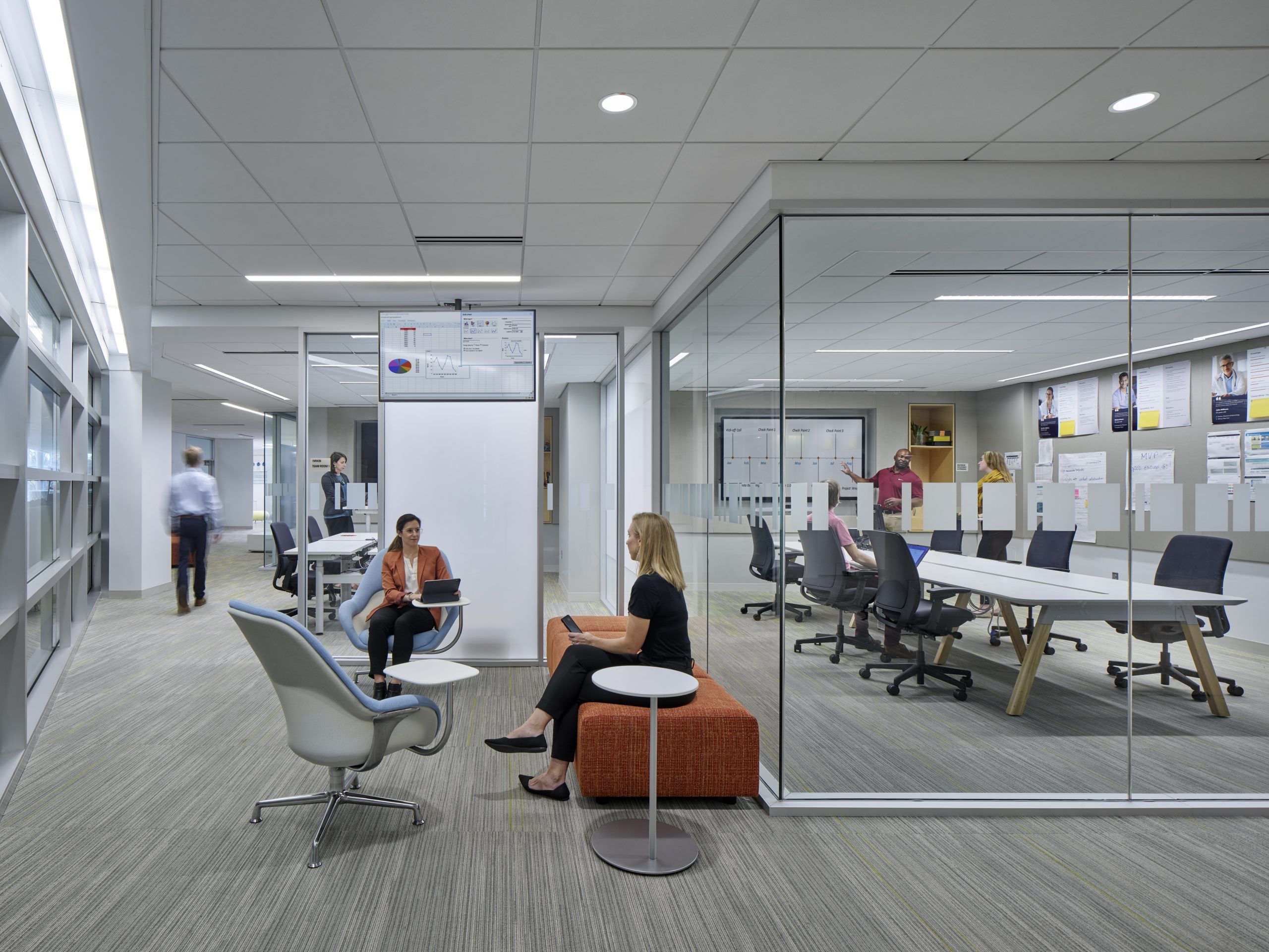 Hallway space with seating area, and conference room in the back