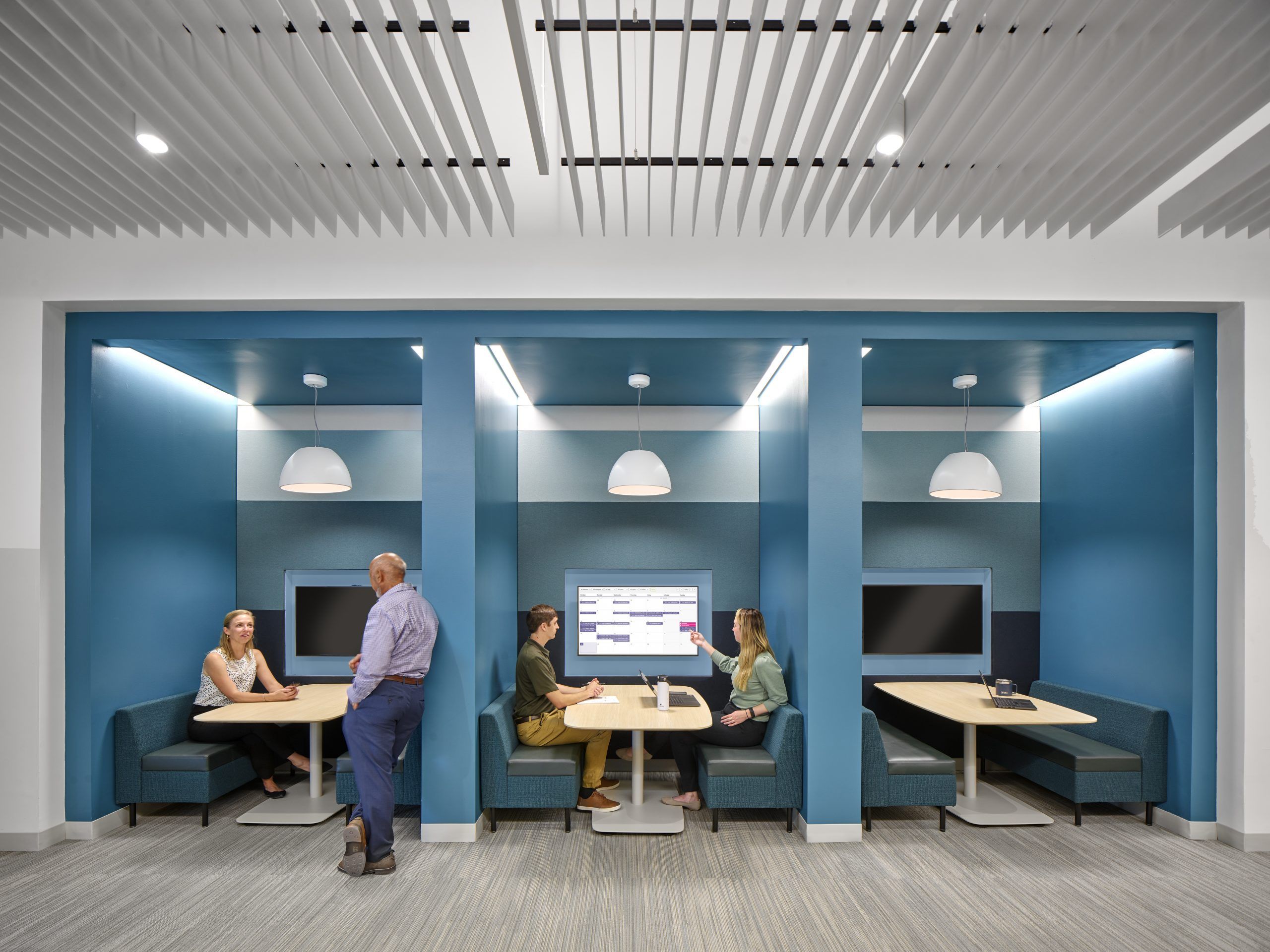 Meeting pods with TV and table to work