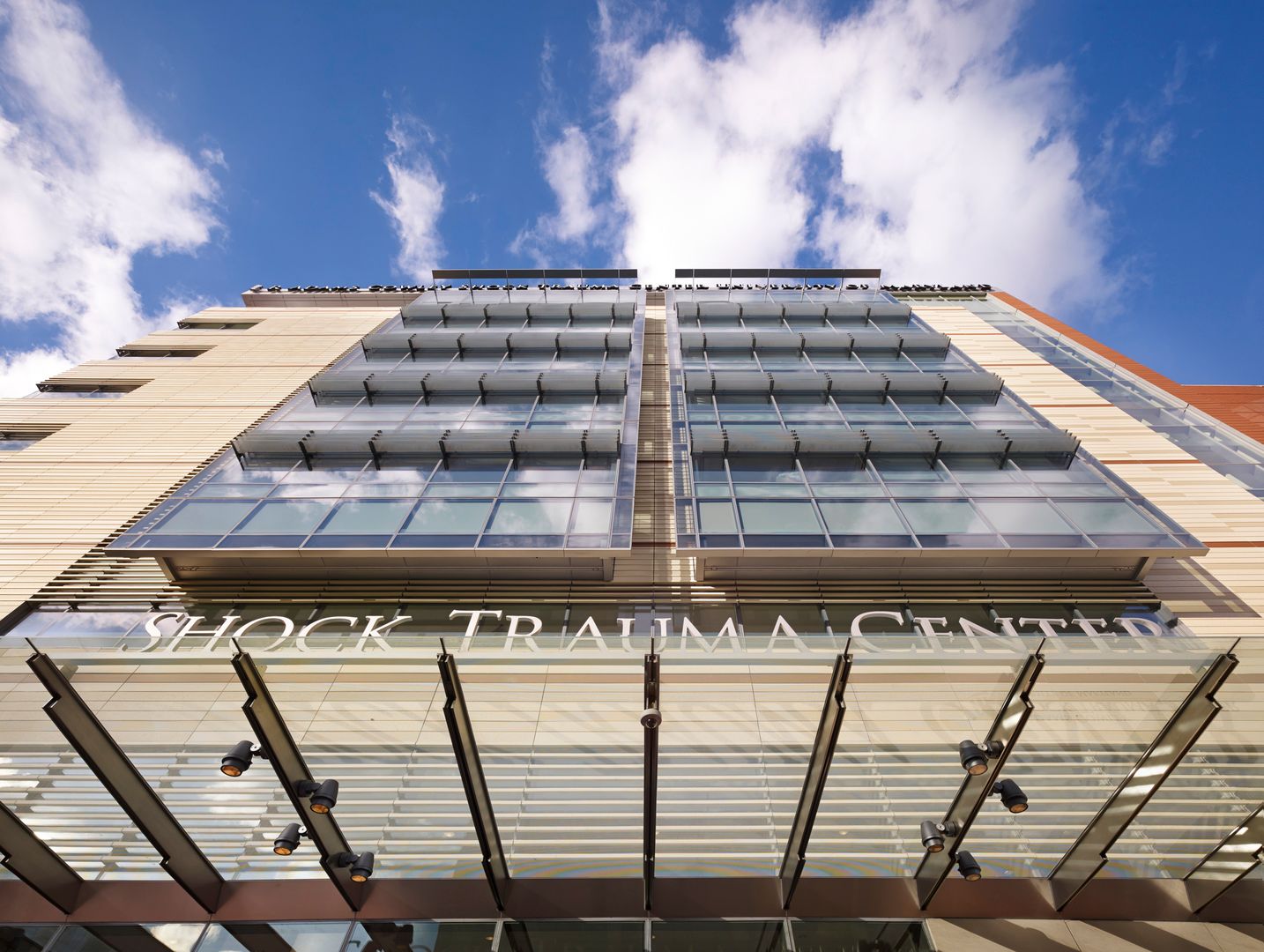 Street view of front entrance looking directly up the facade, "Shock Trauma Center" in foreground above entrance