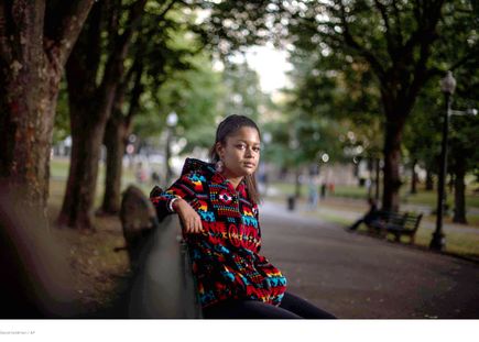 Alyssa Harris sitting on a bench in the park